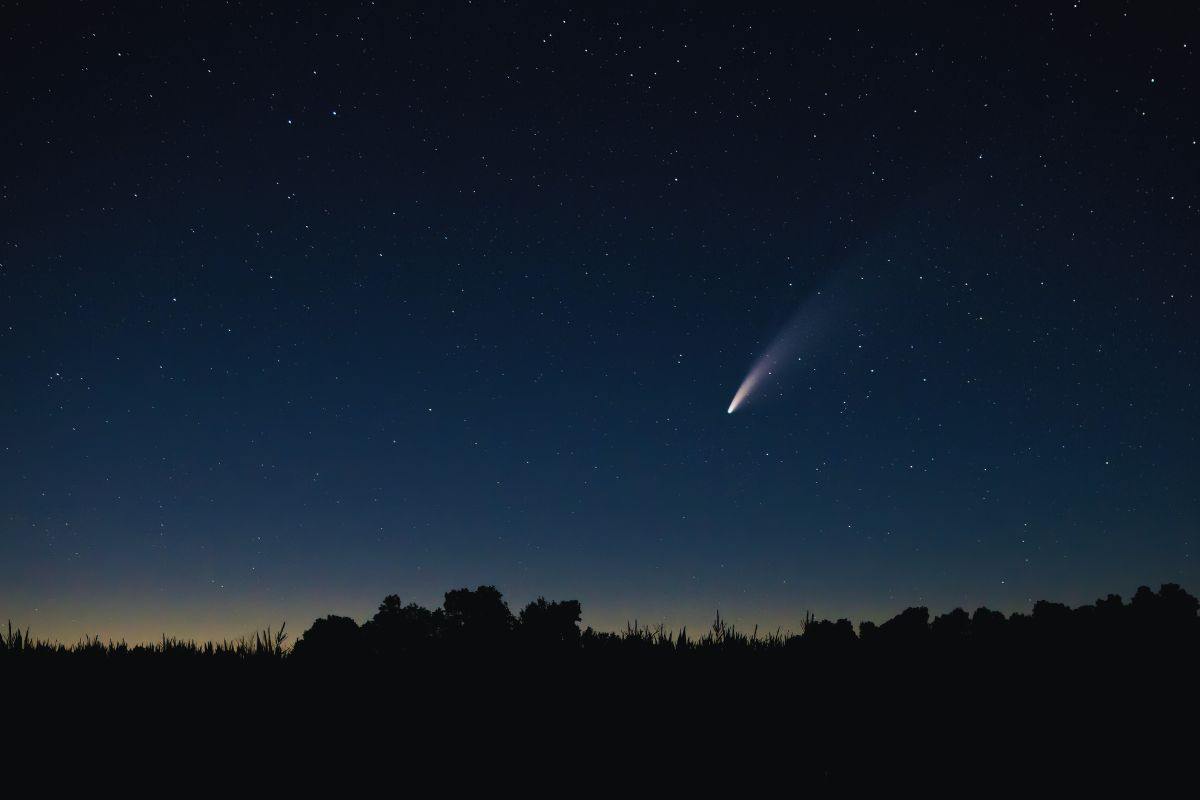Stella cadente che illumina il cielo stellato