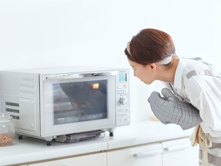 donna che osserva il microonde