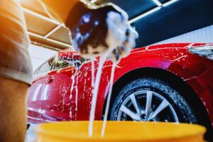 Persona che insapona la propria auto