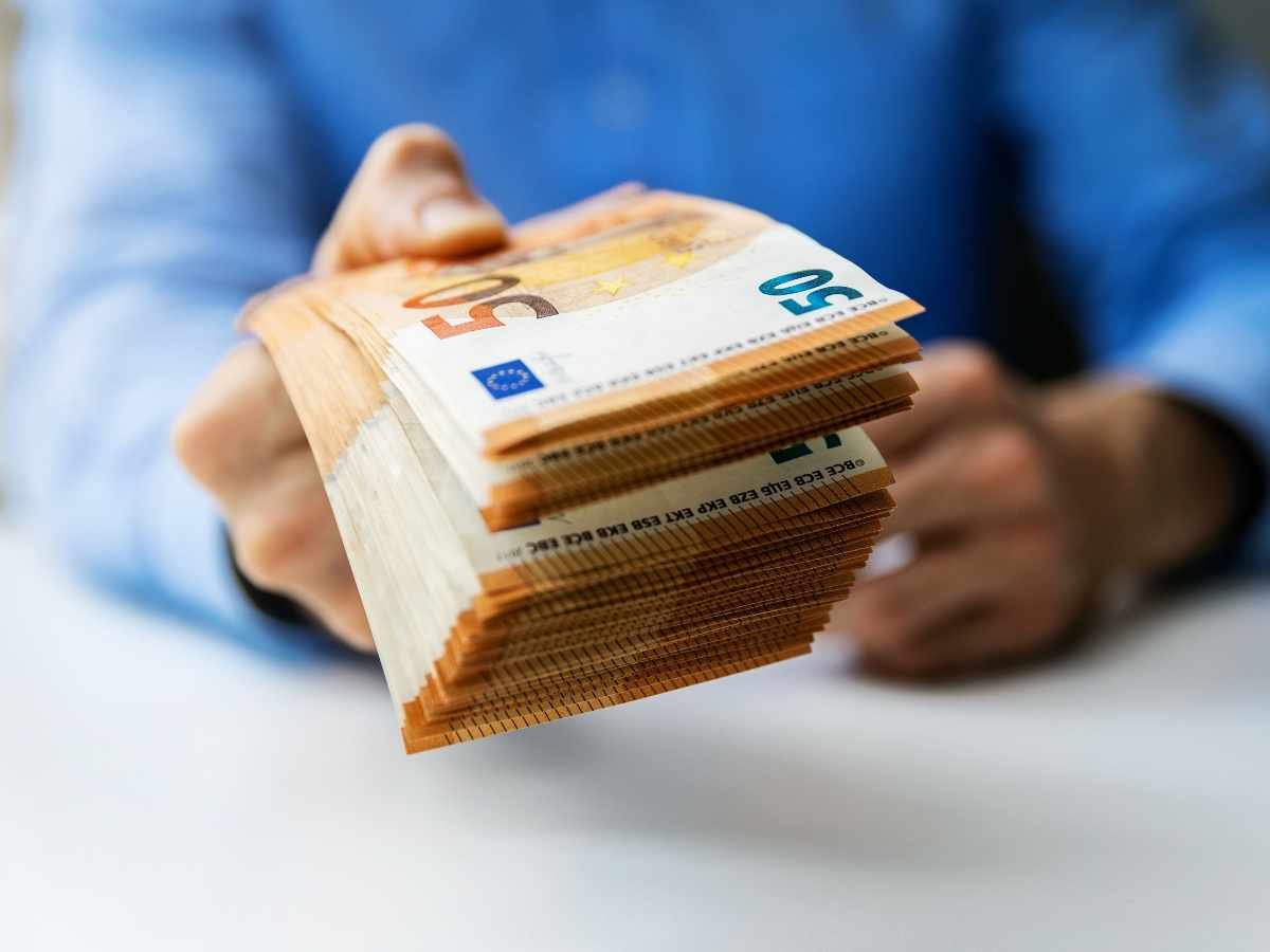uomo che paga con banconote